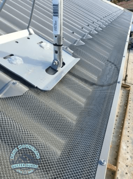 A durable gutter guard installed on a corrugated roof, ensuring long-lasting performance and protection.