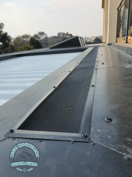 A custom-fitted gutter guard installed on a poorly designed home to prevent leaves from congregating and ensure effective gutter protection.