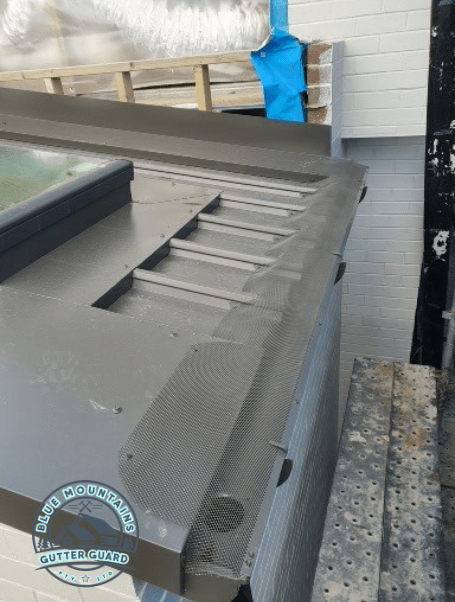 A durable gutter guard installed on a Trimdek Klip Lok roof, ensuring long-lasting performance and protection.
