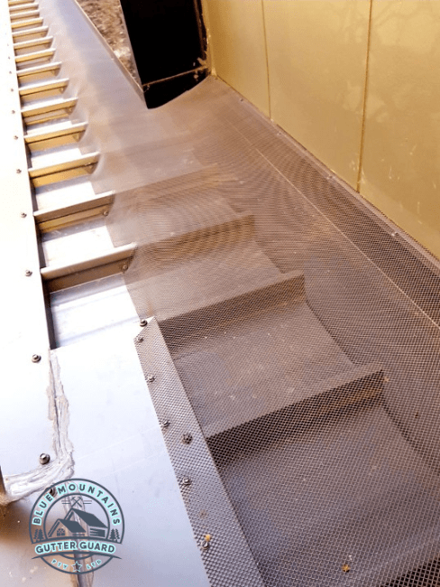 A commercial building equipped with a gutter guard to prevent birds from nesting and ensure clean, functional gutters.