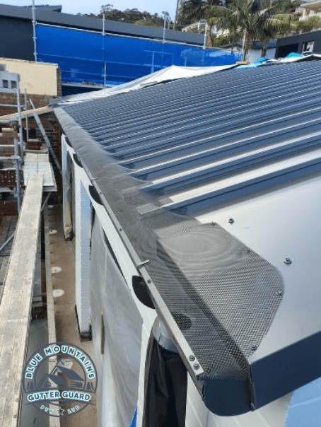 A Trimdek Klip Lok roof equipped with a gutter guard, enhancing home protection by preventing clogs and water damage.