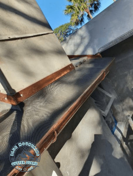A custom-fitted gutter guard installed on copper gutters using specialized copper componentry, ensuring effective protection and a seamless fit.