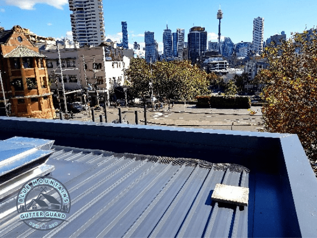 An industrial box gutter equipped with a gutter guard, effectively preventing debris buildup and ensuring optimal performance.