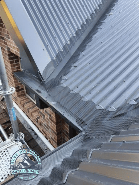 A corrugated roof equipped with a gutter guard, enhancing home protection by preventing clogs and water damage.